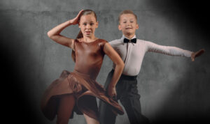 Young girl and boy side by side in dance pose