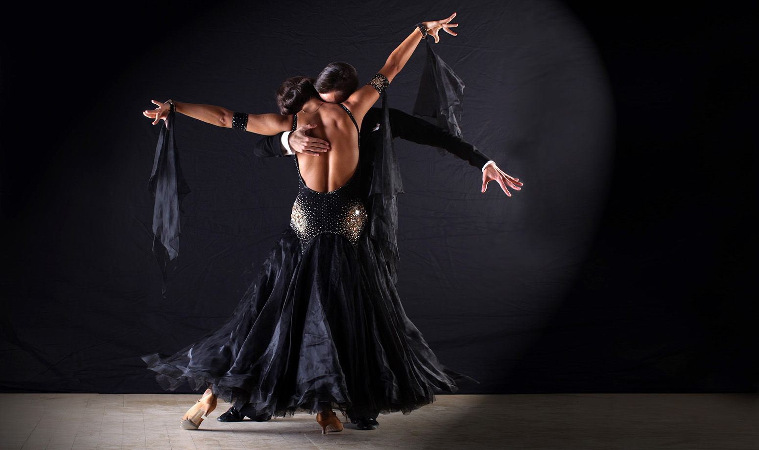 latin dance couple close pose with flowing dance dress