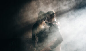 Couple dance closely in smokey environment