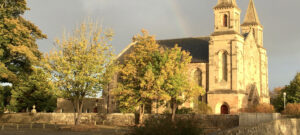 Polmont parish church viewed from road with rainbow in sky