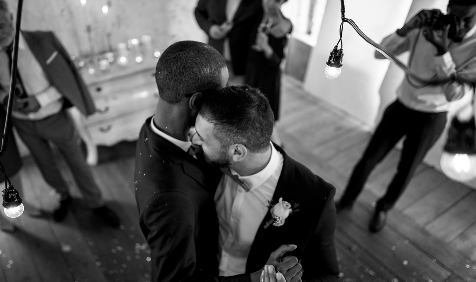 two men dance close at their wedding
